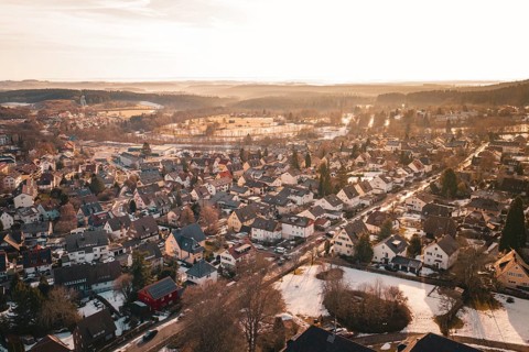 Aerial view of residential area at sunset, snow-covered landscape and rooftops, Freudenstadt, Black