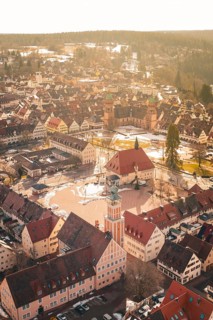 Traditional old town with church and market square, taken from the air in winter light,