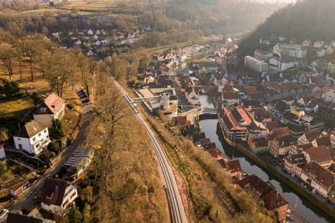 City landscape with train tracks and river from a bird's eye view, measurement trip on the new