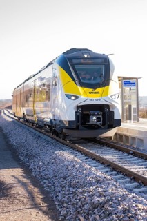 Train on platform in sunny weather, monorail shot, test run on the new Hermann-Hesse railway with