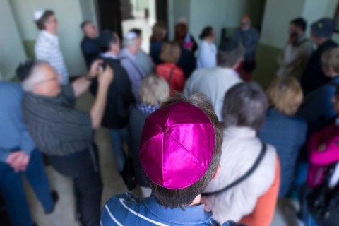 Visitors wear a kippah while visiting a synagogue, Ukraine