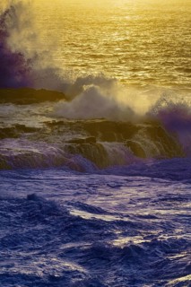 Dusk at sea with big waves and a golden horizon, purple colored ocean, Playa Blanca/Yaiza Lanzarote