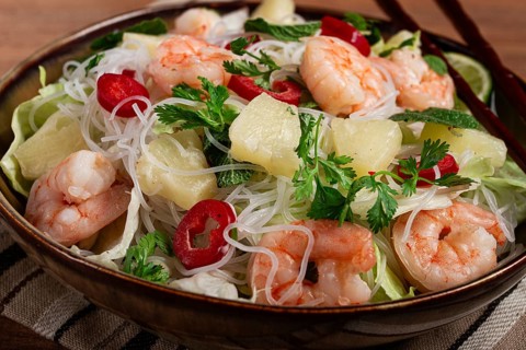 Thai salad with shrimp and rice noodles, pineapple slices, coriander and mint leaves, homemade, no