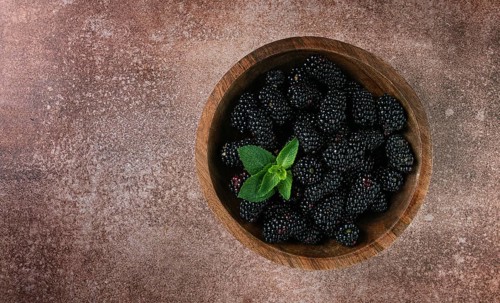 Blackberries, in a wooden bowl, top view, no people