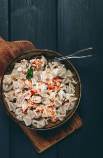 The dish features a generous serving of Turkish dumplings topped with velvety yogurt and a drizzle