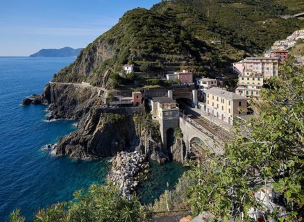 Coastal landscape with houses and view of the train station in the fishing village of Riomaggiore,