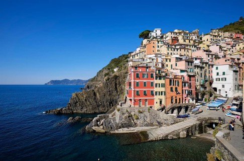 Colourful houses under blue sky, view of the fishing village of Riomaggiore, port, Cinque Terre, La