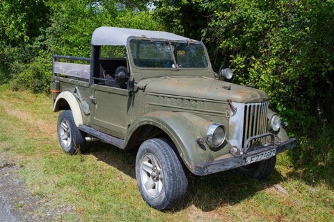 Old green off-road vehicle in rural area with trees and grasses, 4WD vehicle, GAZ-69, Georgia