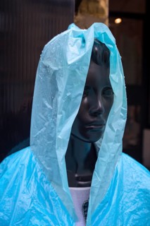 Window mannequin with rain cape in rain, Krakow, Poland