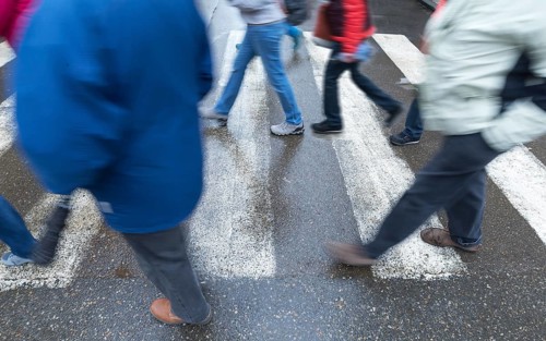 Pedestrians walk across zebra crossings, motion blur, Krakow, Poland