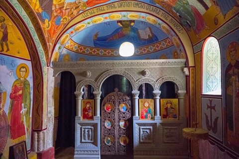 Interior view of an Orthodox chapel with colorful frescoes and icons, Nikorzminda Cathedral,