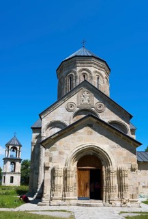 Historic stone church with bell tower against a clear sky, Nikorzminda Cathedral, Nikorzminda