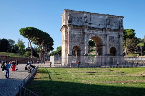 Arch of Constantine with tourists on sunny day, Lazio, Italy