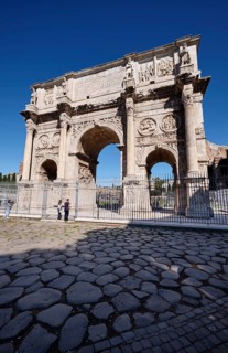 Arch of Constantine with detailed reliefs under blue sky, Rome, Lazio, Italy