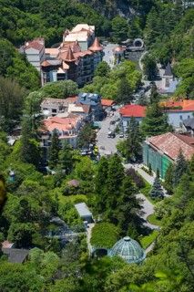 Bird's-eye view of the city with buildings and dense forests and green areas, Borjomi, Borjomi,