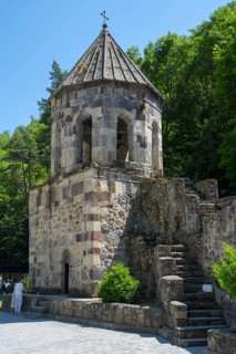 Stone bell tower with stairs in a wooded area, Chitakhevi Church of St. George, The Green