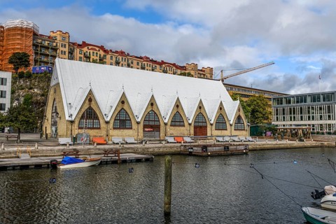Large historic market hall in Gothenburg with pointed roof on the water, Gothenburg, Västra