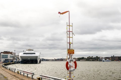 Stena Line fast ferry catamartan in port on a cloudy day with lifebuoy in the foreground, Stena
