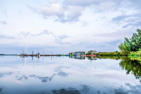 Tranquil Dümmer See with several boats in the harbor and clouds, Dümmerlohausen, Damme, Lower