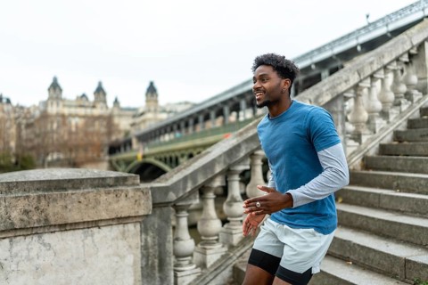 Young black man training and exercising stairs in paris, enjoying fitness and urban lifestyle with