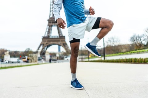 African american male athlete engaging in a high knee exercise or warm up routine, demonstrating