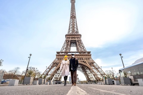 Young happy couple walking hand in hand during their city trip through paris, exploring the iconic