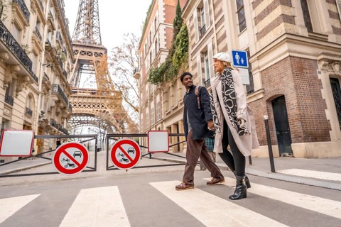 Loving couple enjoying a romantic leisure walk in a charming parisian neighborhood, crossing a