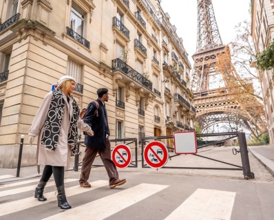 Diverse couple crossing a pedestrian street in paris, enjoying a city trip together with classical