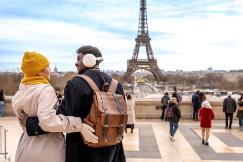 Young diverse couple embracing, traveling to paris, france, enjoying a romantic trip, sightseeing