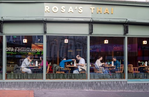 People eating at tables inside Rosa's Thai restaurant, Kings Road, Reading, Berkshire, England, UK
