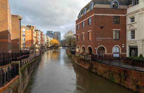 River Kennet flowing past apartment housing and businesses, view east from London Street, Reading,