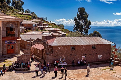 A picturesque village in the Andes with traditional buildings surrounded by mountains and clear