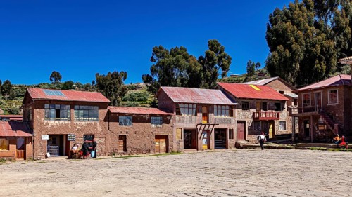 Traditional houses in a quiet village in the Andes, surrounded by nature and under a clear sky, The
