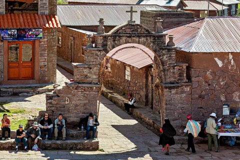 A bustling marketplace in a traditional village with stone walls and arches, The city's large