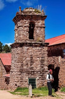 Stony church tower with red roof and a man wearing traditional clothes next to it, The knitting men