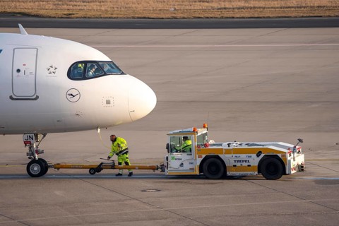 Lufthansa City Airbus A320neo is pushed from the gate onto the taxiway, ready to go, to
