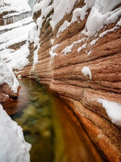 Taugl or Tauglbach flows through the snow-covered and icy red gorge, also Marmorklamm, Bad Vigaun,