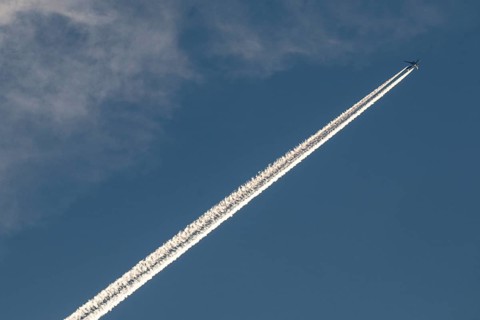 Contrails and passenger jets high in the sky