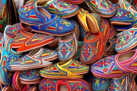 Sales stand with traditional colorful slippers at a market in Marrakech, historic old town, Medina,