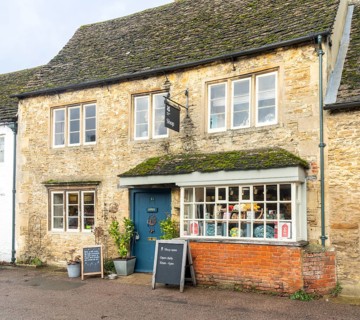 National Trust shop in historic Cotswold stone building, village of Lacock, Wiltshire, England, UK
