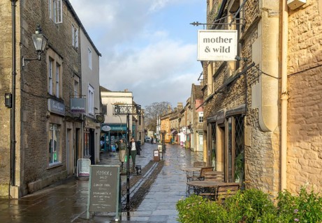 Wet pavements after rain in pedestrianised High Street are of town centre of Corsham Wiltshire,