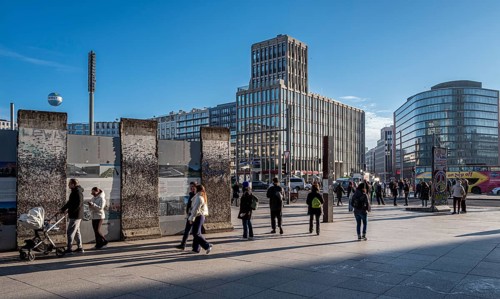 Wall segment, tourists and passers-by at Potsdamer Platz, Berlin, Germany