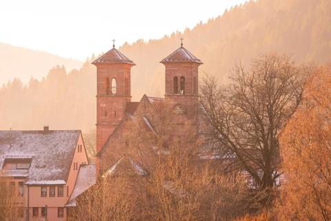 Church towers and buildings in a snowy village near Bergen, Black Forest, Germany
