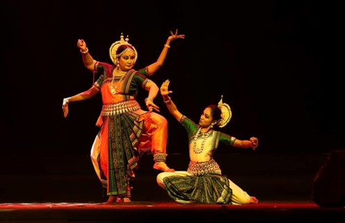 Artists perform Odissi classical dance during a cultural evening program at Shilpgram Mohotsav 2026