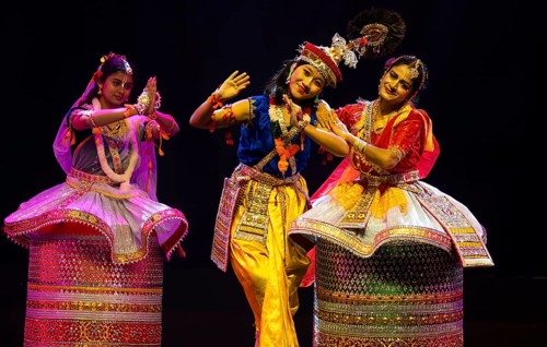 Artists perform classical Manipuri Ras Leela during a cultural evening program at Shilpgram