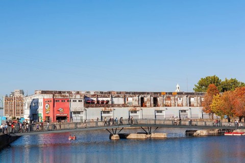 Pedestrian walkway bridge over Bonsecours basin leading to Parc du Bassin Bonsecours in autumn, Old