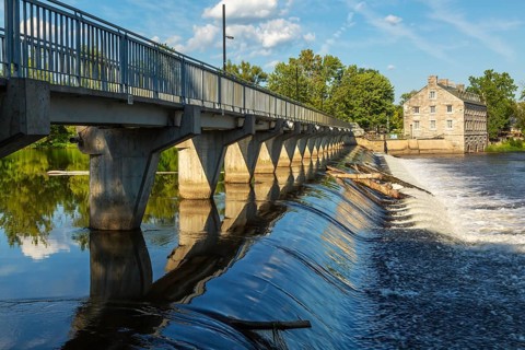 Moulin Neuf water flow control dam and walkway over Des Mille-Iles river plus New Mill on Ile des