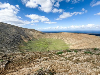 View of the Caldera Blanca volcano cauldron against blue sky with white clouds, Mancha Blanca,