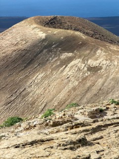 View from Caldera Blanca volcano against blue sky with white clouds, Mancha Blanca, Lanzarote,
