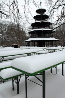 Winter in the English Garden, snow-covered beer garden tables and benches, Chinese Tower, Munich,